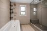 The second floor bathroom has both a tub and a shower.