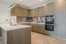 Bespoke kitchen with composite stone worktops and island in a Pavilion apartment, Sunningdale Park