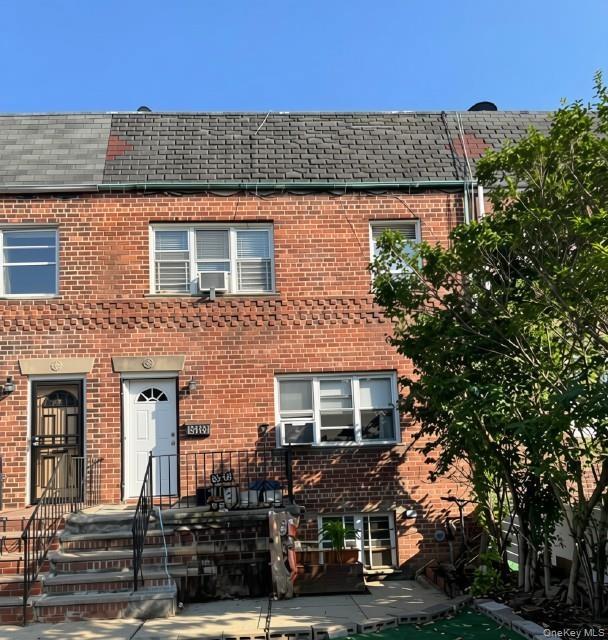 Brick exterior with partial shingle roofing
