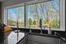 Kitchen window overlooking a landscaped exterior