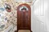 Charming Vestibule with wallpaper and coat closet