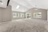 large bonus room with 1/2 bath ensuite with doors to back yard