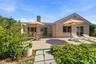 large concrete patio in back of home