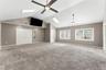 large bonus room with french doors into primary bedroom