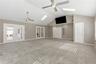 large bonus room with french doors into dining/formal living room and primary bedroom