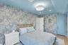 Hardwood-style flooring with a blue-painted ceiling, recessed lighting, and a contemporary ceiling fixture