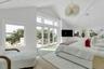 Spacious room featuring vaulted ceilings, a contemporary chandelier, recessed lighting, and light wood-finish flooring