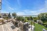 Spacious outdoor deck featuring wood-finish decking and a modern cable railing system