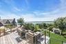 Expansive wood-finish deck with cable railing