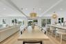Open concept living space featuring light wood-finish flooring, recessed lighting, and multiple sliding glass doors