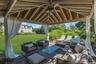 Covered patio featuring a wood-finish ceiling, central ceiling fan, and privacy drapes