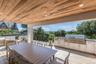 Expansive covered outdoor deck featuring a wood-finish ceiling, recessed lighting, and wood-finish flooring