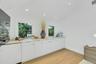 Built-in cabinetry with a light-toned countertop, integrated sink, and contemporary faucet