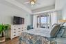 Primary bedroom provides light and views from sliders in master bedroom