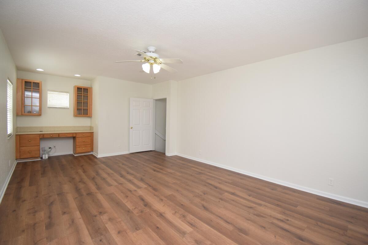 Upstairs family room with desk and balcony.