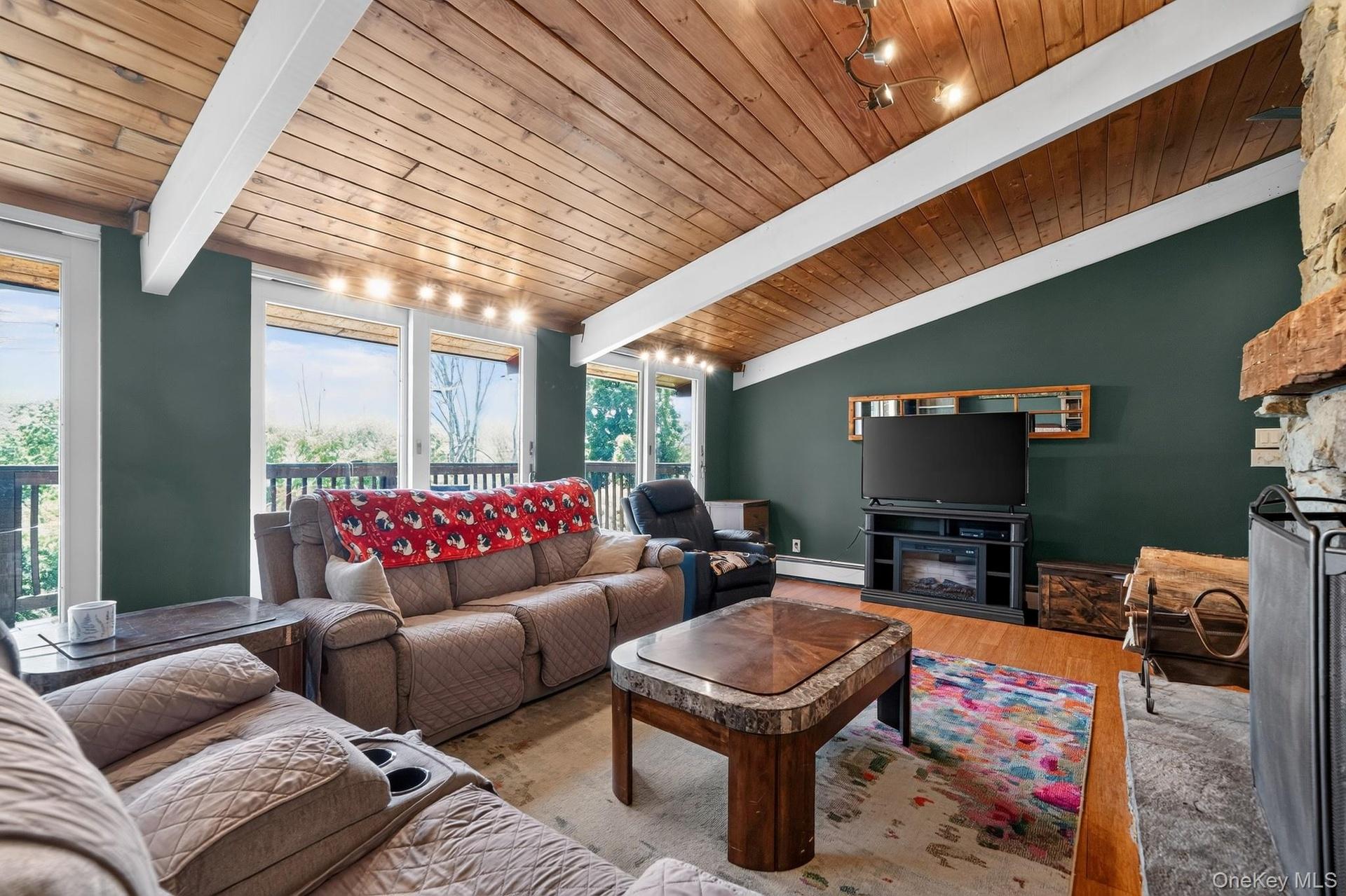 Vaulted wood-paneled ceiling with exposed white beams