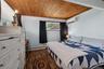 Room featuring wood-finish flooring, a natural wood paneled ceiling, and light blue walls