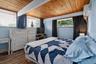 Wood-plank ceiling with exposed beams