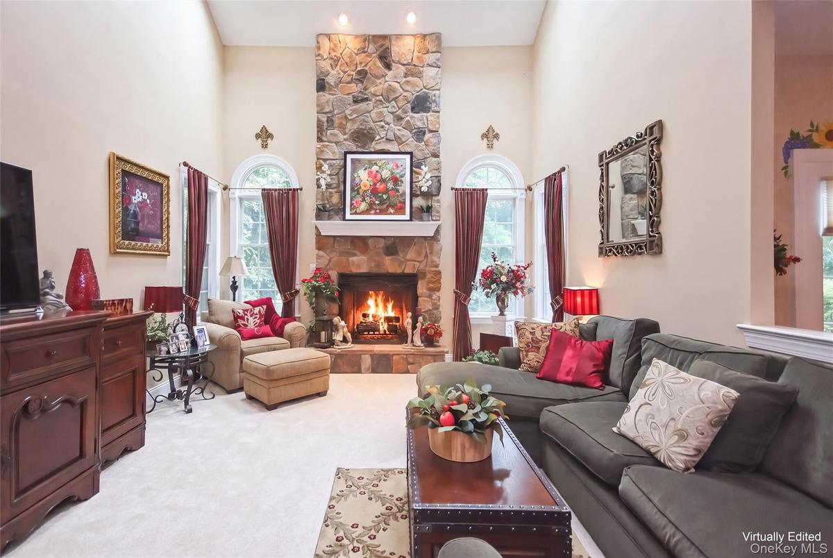 Family room w/ soaring stone gas fired fireplace