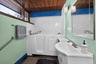 Bathroom featuring a walk-in tub, white subway tile surround, wood-finish ceiling, and an integrated vanity sink with storage
