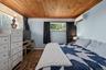 Room featuring a wood-finish ceiling, light blue walls, and wood-finish flooring