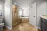 Primary bathroom tub and shower.