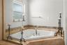 Primary bathroom large corner tub.