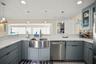 Kitchen facing the sink and breakfast bar.