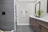 Bathroom featuring a double vanity with dark wood cabinetry, white countertops, and integrated sinks