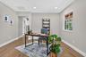 Room featuring wood-finish flooring, recessed lighting, a single window, and a doorway
