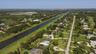 Expansive aerial perspective showcasing a waterway bordered by residential properties