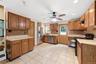 Spacious kitchen featuring extensive cabinetry, tile flooring, stainless steel refrigerator, stainless steel dishwasher, and Lots of countertop space 