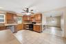 Enjoy your Eat-in Kitchen featuring wood cabinetry, mosaic tile backsplash, with a door that leads out to a deck off of the kitchen in your private ba
