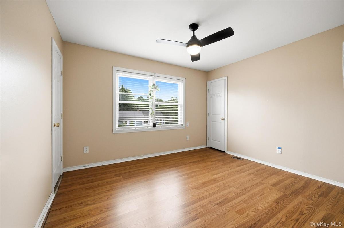 1 of 2 bedrooms on the 2nd floor.  House has 3 Bedrooms. Window facing the front yard with the white picket fence.