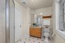 This thoughtfully positioned bathroom provides flexibility with access from the bedroom and hall.