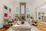Vaulted ceilings, walls of windows, and a floor-to-ceiling brick fireplace define this spectacular family room.