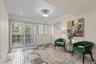 Located on the lower level, a charming sitting area welcomes you in from the backyard, creating a cozy transition between indoor and outdoor living.