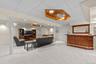 Large and versatile recreation space with a dedicated bar, recessed lighting, and carpeting—ideal for movie nights, game days, and gatherings.