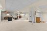 Designed for effortless entertaining, this expansive recreation space features a refrigerator, cabinetry with sink, and high ceilings, creating a vers