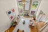 The upper-level balcony overlooks the expansive family room, enhancing the home's open, airy design.