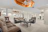 Thoughtfully designed, this recreation space features a dedicated exercise alcove, ceiling fans, and a beautifully crafted ceiling detail.