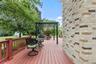 Freshly painted deck with a charming pergola, creating an inviting outdoor retreat for relaxing and entertaining.