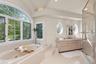 Designed for relaxation, this sophisticated bathroom features two vanities and a tranquil soaking tub.