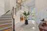 An elegant grand foyer filled with natural light and classic architectural details.