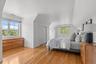 An inviting bonus room featuring high ceilings, ample closet space, and warm hardwood flooring. Although staged as a bedroom it is considered addition