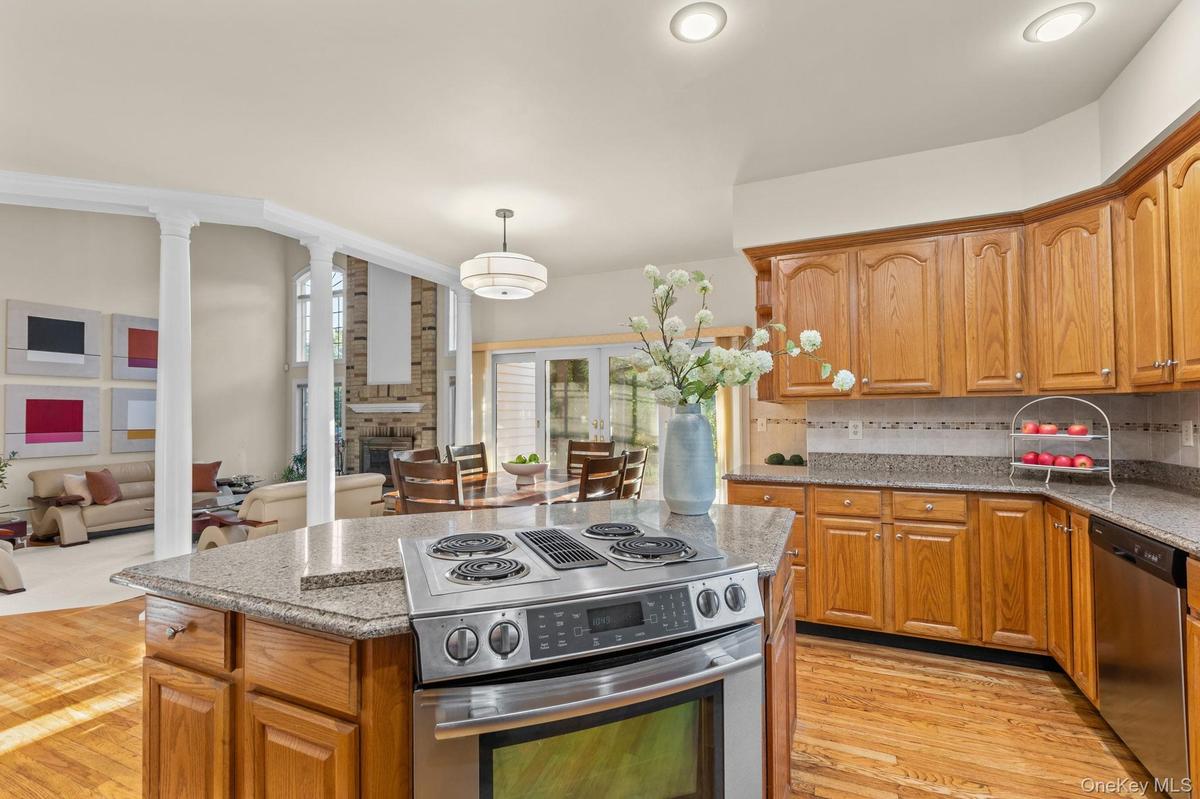 A warm and welcoming kitchen with hardwood floors, open to the family room for effortless entertaining.