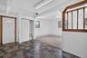 Multi-color slate tile flooring at entry, featuring a white door with an arched window, and a built-in closet with louvered bi-fold doors and shelving