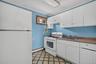 1st Floor Kitchen featuring white cabinetry, a stainless steel sink, and a gas range