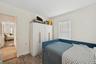 Bedroom featuring wood finished floors and ornamental molding