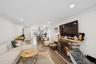 Living area featuring crown molding, a stone fireplace, wood finished floors, and recessed lighting